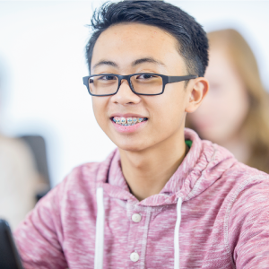 Female Tutor and student writing on activity sheet
